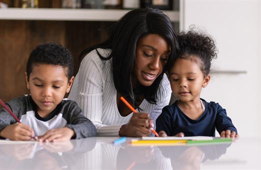 Mother helping children with homework