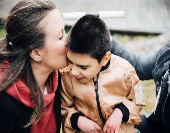 Mother kissing child on the head